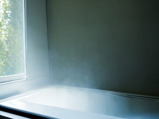 Steam rising from a bathtub near a window, with soft light illuminating the scene.